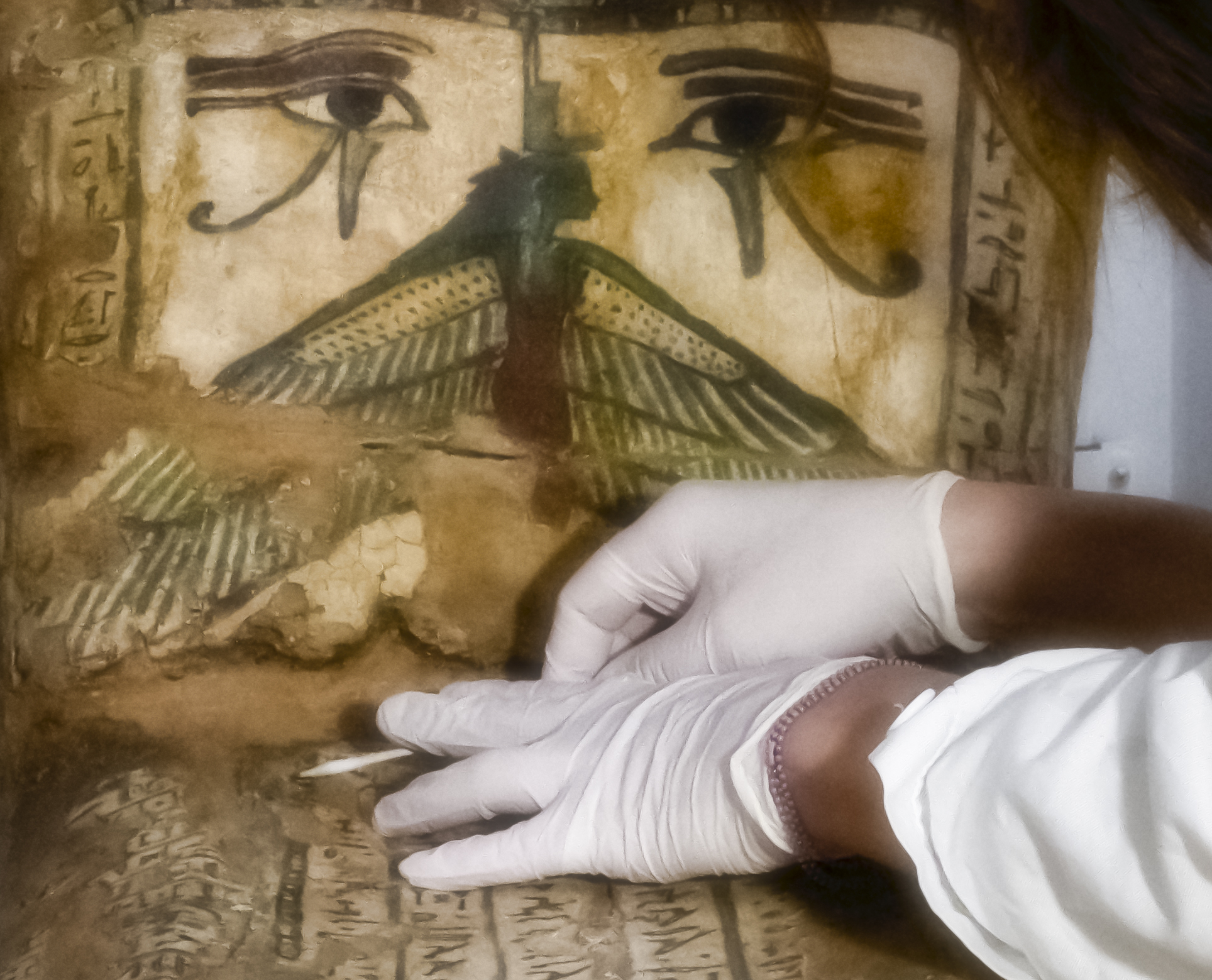 Detail of hands cleaning a sarcophagus
